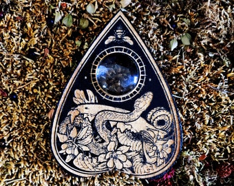 Ouija, esotericism and ouija board, planchette and spiritualism, occult art, serpent, Lilith, Cabinet of curiosities.