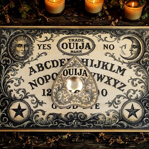 May include: A vintage Ouija board with a planchette. The board features the alphabet, numbers, and the words "Yes" and "No." Ornate black and white designs frame the board, with a sun and moon illustration. The planchette is heart-shaped.