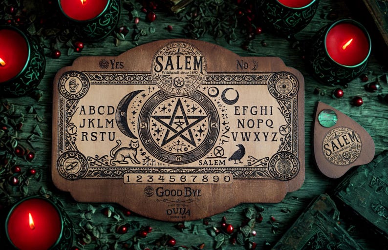 May include: A wooden Ouija board with the word "Salem" and a star symbol in the center. The board features letters, numbers, and the words "Yes," "No," and "Good Bye." The image includes a planchette and lit red candles.