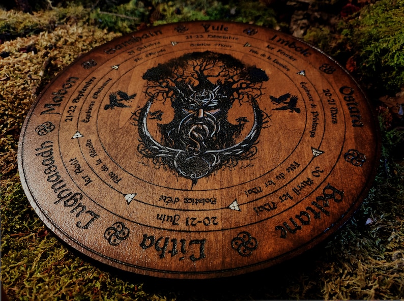 May include: A wooden wheel with a Celtic knot design and a tree of life illustration. The wheel is divided into eight sections, each representing a different season or sabbat. The text on the wheel includes the names of the sabbats in English and the dates they occur.