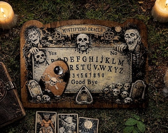 May include: A wooden spirit board titled Mystifying Oracle featuring illustrations of two zombies, multiple skulls, and two tombstones marked RIP. The board displays the alphabet, numbers 0-9, Yes, No, and Good Bye, accompanied by a planchette with a skull.