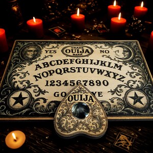 May include: A wooden Ouija board with a planchette, surrounded by lit red candles. The board features the alphabet, numbers, and the words "YES" and "NO". The planchette has a clear gem in the center and is decorated with floral designs.