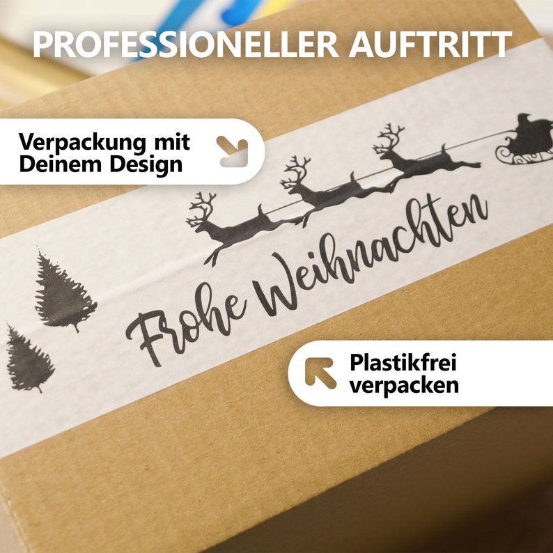May include: A brown cardboard box with a white strip featuring a black illustration of reindeer pulling a sleigh and the words "Frohe Weihnachten." The box also has text that says "Professional Appearance" and "Packaging with Your Design."