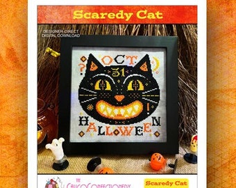 May include: Cross stitch pattern for a Halloween design featuring a black cat with a scary grin and the text "Oct 31 Halloween".