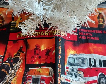 May include: A red and black fabric Christmas tree skirt with a fire department theme. It features images of fire trucks, firefighters, and the words "Fire Department" and "Fire Fighters Save Hearts and Homes".