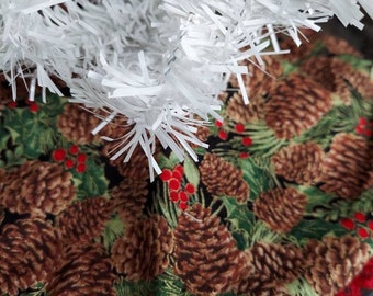 Mini 10 inch diameter pine Cones and holly tree skirt.