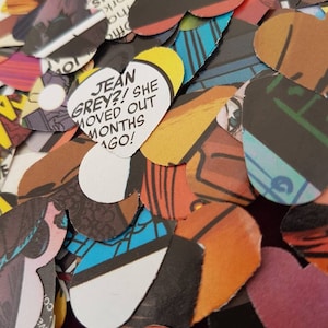 May include: A pile of colourful heart-shaped paper cutouts with comic book images and text. One heart reads "JEAN GREY?! SHE MOVED OUT MONTHS AGO!"