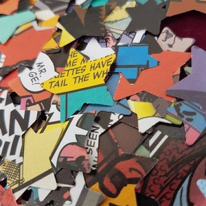 May include: A pile of colourful star-shaped confetti made from recycled comic book pages. The confetti features various images and text, including "Mr. G!" and "Tail the Whiz".