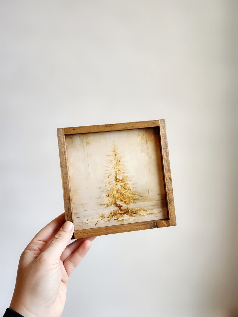 May include: A framed print of a vintage Christmas tree with gold ornaments and a white background.