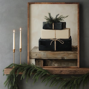 May include: A framed painting depicts a stack of wrapped gifts, two black and one cream-colored, adorned with twine and greenery. Two lit candles in gold holders and a garland of evergreen branches complete the holiday scene.