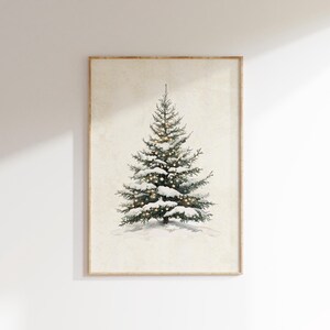 May include: A framed watercolor painting of a snow-covered evergreen tree with white lights strung through the branches.