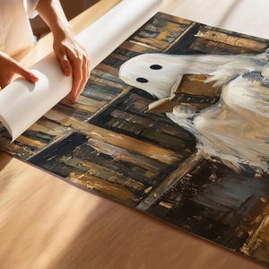 May include: A white ghost with a book in its hands, sitting in a library with shelves full of books. The books are painted in shades of brown, yellow, and green.