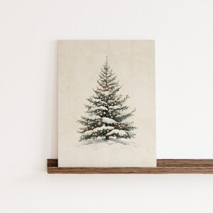May include: A snowy evergreen tree with white snow and twinkling lights on a beige background.