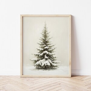 May include: A framed print of a snow-covered evergreen tree against a white background.