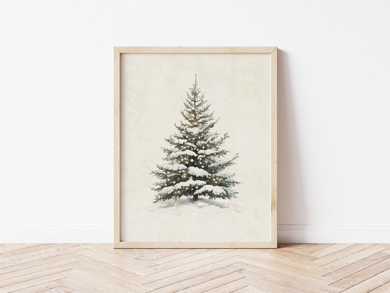 May include: A framed print of a snowy evergreen tree with white lights. The tree is centered on a cream background.