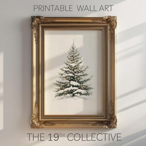 May include: A printable wall art print featuring a snowy Christmas tree with white snow and twinkling lights in a gold frame. The print is titled "THE 19TH COLLECTIVE".