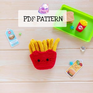 May include: Crochet pattern for a cute french fries amigurumi toy. The toy is red and yellow and has a happy face. The pattern is available as a PDF download.