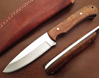 May include: A brown wooden handled knife with a stainless steel blade and a leather sheath.