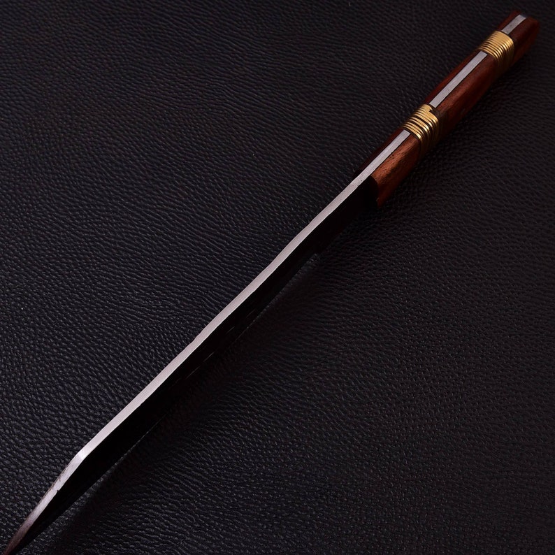 May include: A long, silver blade with a wooden handle wrapped in brass wire. The handle is dark brown and the blade is shiny.