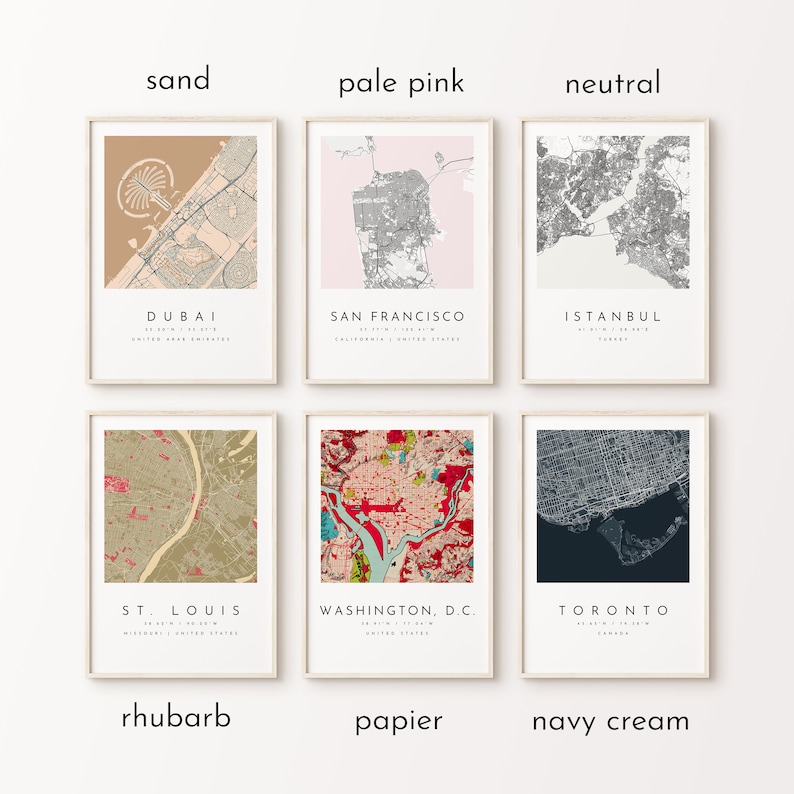 May include: Six framed city map prints in various color schemes, including sand, pale pink, and navy cream. Each print features a different city name, such as Dubai, San Francisco, and Toronto, with coordinates and country listed.