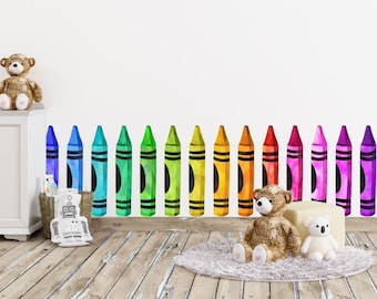 May include: A row of colorful crayon-shaped wall decals in a rainbow pattern, with a teddy bear and a robot toy in the foreground.