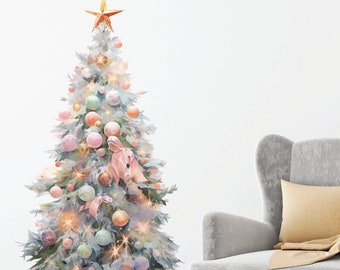 May include: A white Christmas tree with a gold star on top, decorated with pastel colored ornaments and lights. The tree is in front of a white wall and a gray armchair with a tan throw blanket.