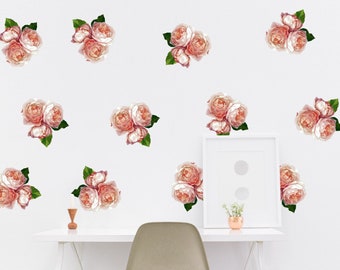 May include: A white wall with a desk and chair, decorated with multiple pink and green floral decals. The decals are of various sizes and are arranged in a symmetrical pattern.