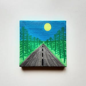 May include: A painting of a road leading through a forest with a yellow sun in the blue sky.