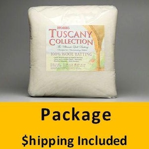 May include: A package of Hobbs Tuscany Collection 100% Wool Batting. The package is rectangular and filled with a light cream-colored material. A label on the front features the brand name and product details. The background is a neutral gray.