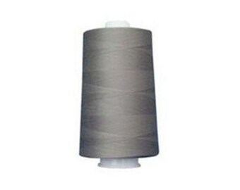 May include: A spool of gray thread, ideal for sewing projects. The thread is tightly wound around a cylindrical core with a white base and top. The thread appears to be a medium weight and is suitable for various fabrics.