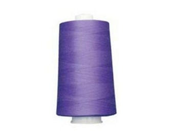 May include: A large spool of purple thread, ideal for sewing and crafting projects. The thread is tightly wound around a white plastic base, creating a conical shape. The thread's color is a vibrant shade of purple.