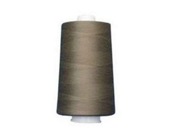 May include: A spool of brown thread, ideal for sewing and crafting projects. The thread is wound around a cylindrical core with white plastic ends. The thread has a slightly textured appearance.