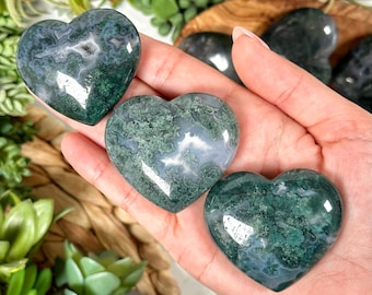 May include: Three green and white agate heart-shaped stones. The stones have a swirling pattern of green and white.