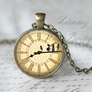 May include: A bronze necklace with a round glass pendant featuring a vintage clock face with Roman numerals and a silhouette of five figures walking across the clock face. The necklace is on a white surface with writing.