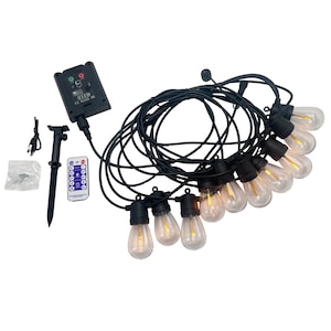 May include: A set of 10 LED string lights with a remote control and a solar panel. The lights are warm white and have a black wire. The solar panel has a black case with a digital display and a red and green light.