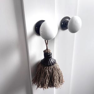 May include: A handmade wooden sign with the text "Welcome" in a playful font. The sign features a distressed, rustic finish and a simple, inviting design, perfect for a front door or entryway.