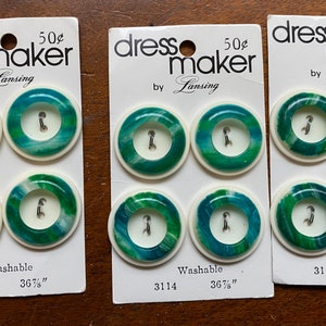 May include: Three cards of green and white swirl buttons with a white background. The cards are labeled "dress maker" with the price of 50 cents. The buttons are 36 7/8 inches in size and are washable.