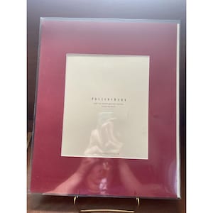 May include: A red mat for wood gallery frames, 8 x 10 inches (20.3 x 25.4 cm), from Pottery Barn.