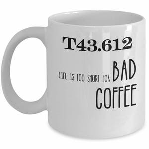 May include: White ceramic coffee mug with black text that reads "T43.612 Life is too short for bad coffee".