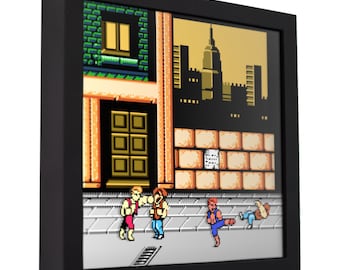 May include: A framed pixel art print of a scene from the classic video game, Double Dragon. The scene depicts the two main characters, Billy and Jimmy Lee, fighting against a group of enemies in a city street. The background features a cityscape with a tall building in the distance.