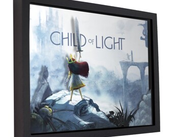 May include: A framed print of a video game artwork featuring a young girl with red hair holding a sword, standing on a rock formation. The background is a misty, blue landscape with a castle in the distance. The title "CHILD OF LIGHT" is written in white letters across the top of the image.