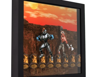 May include: A framed pixel art print of two video game characters fighting on a platform. The characters are a blue and silver robot and a red warrior with a sword. The background is a sunset over a rocky landscape.