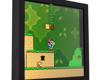 May include: A framed pixel art print of a video game scene featuring a character riding a dinosaur. The scene is set in a green forest with a vine hanging from the top. The character is wearing a red hat and overalls. The dinosaur is green and has a long neck. The print is surrounded by a black frame.