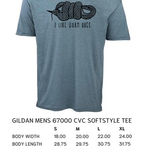 May include: A blue Gildan Mens 67000 CVC Softstyle tee shirt with a black snake graphic and the text "I LIKE WARM HUGS". The shirt's body width ranges from 18 to 24 inches, body length from 28.75 to 31.75 inches, and sleeve length from 16.50 to 19.50 inches.