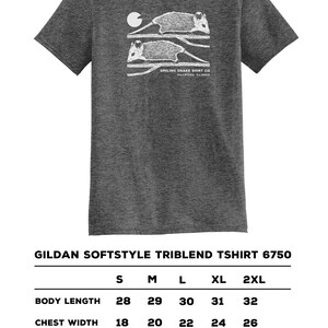 May include: Dark grey Gildan Softstyle Triblend T-shirt featuring a white graphic of two opossums on a branch, a moon, and text. Sizes S-2XL available. Body length: 71-81 cm. Chest width: 46-66 cm.