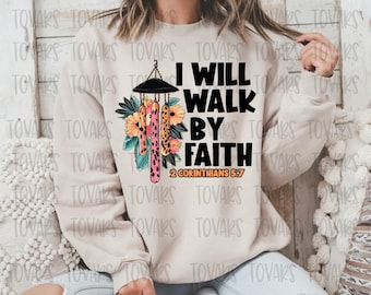 May include: A beige sweatshirt with the text "I will walk by faith 2 Corinthians 5:7" and a graphic of a wind chime with floral accents.