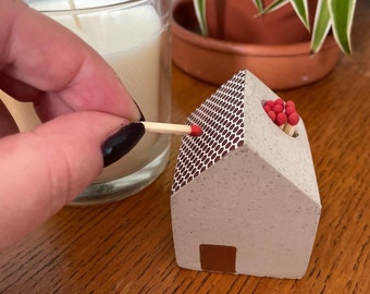 Concrete house match holder with striker