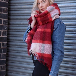 model wearing a red tartan scarf