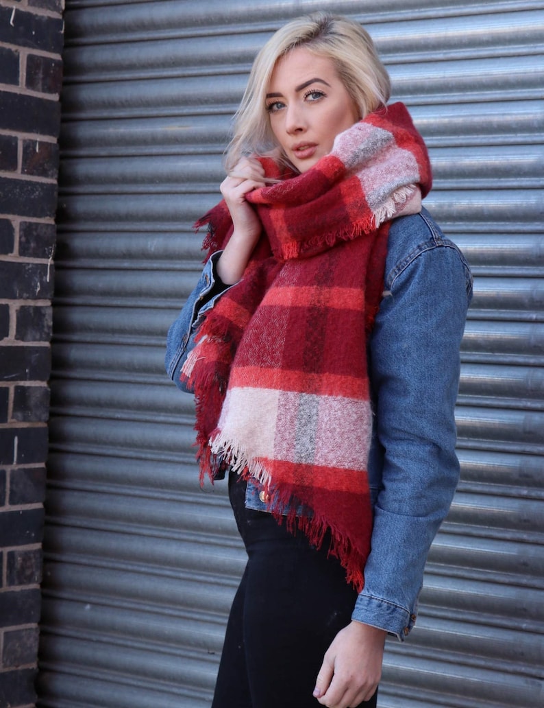 model wearing a red tartan scarf