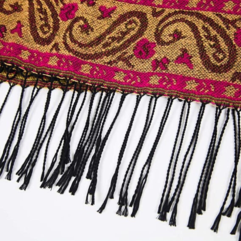 close up of the tassels on the edge of the bohemian poncho
